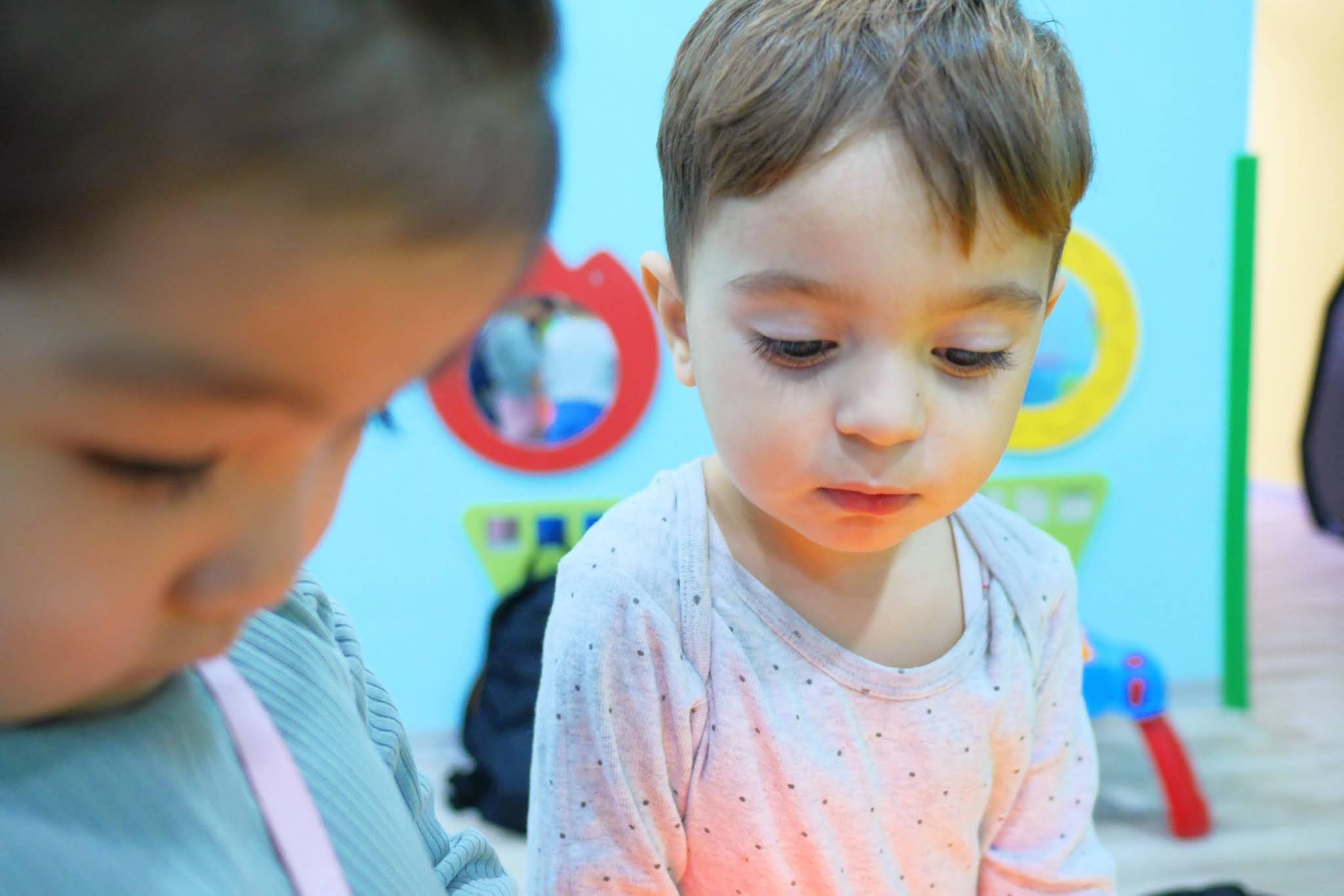Two toddlers painting together