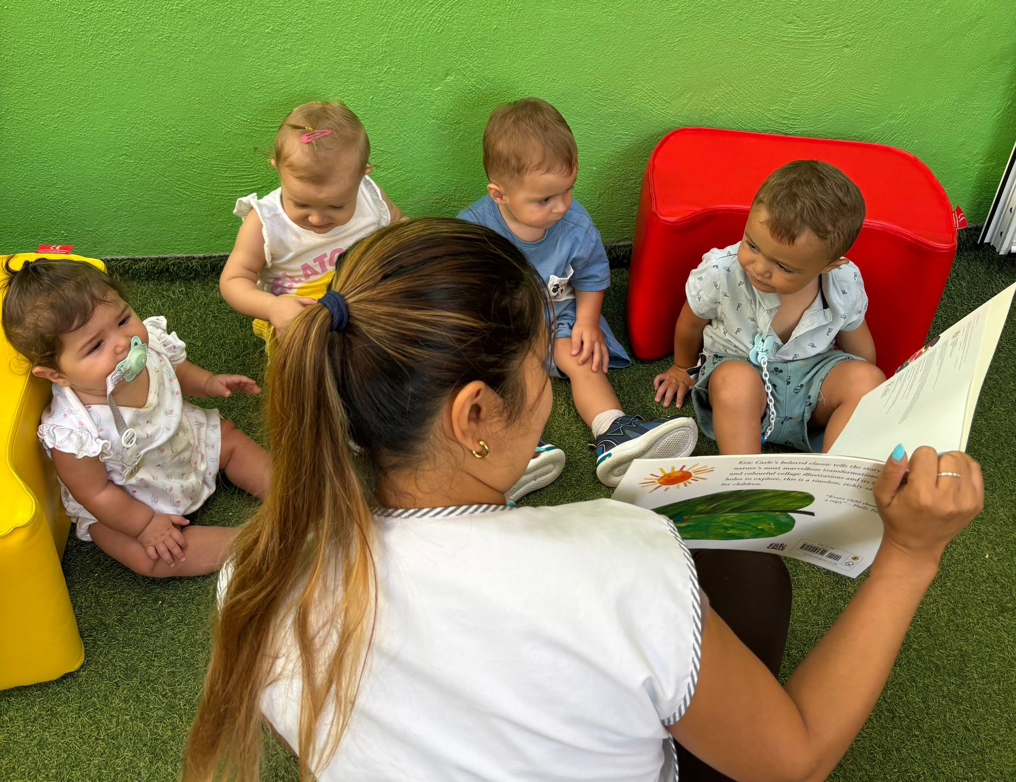 Educators guiding children through a playful activity